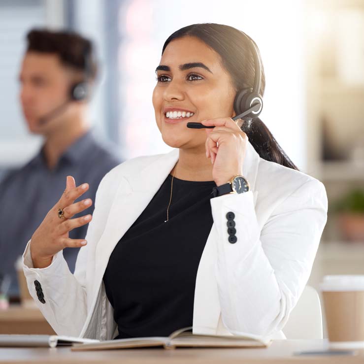 PaySave support representative wearing a headset at a call centre workstation